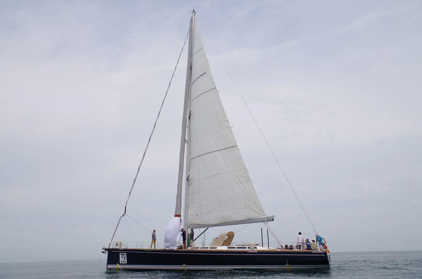 A sleek sailing yacht glides gracefully on calm waters under a cloudy sky. aboard MAZARIN 72 CRUISER RACER Yacht for Sale