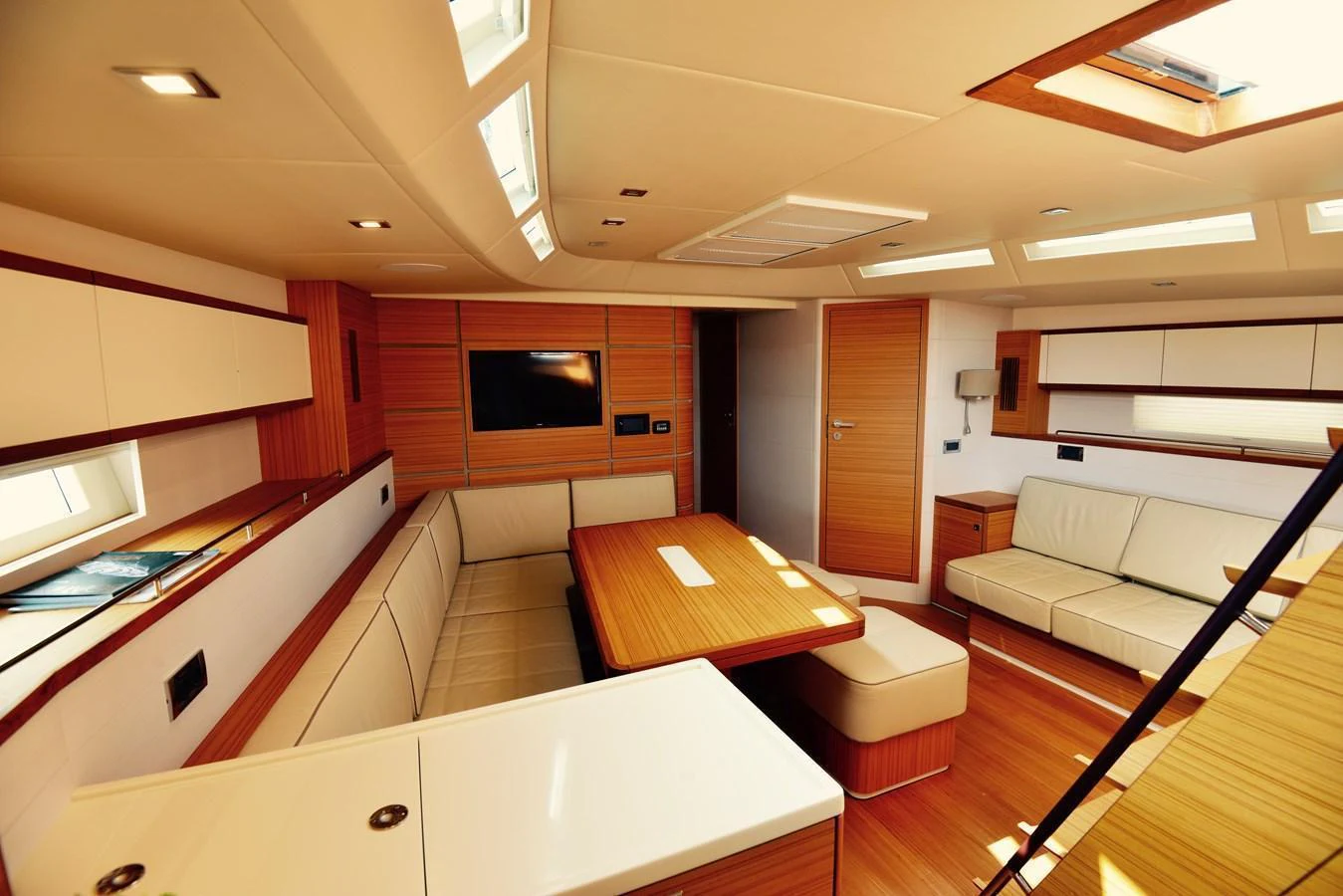 The yacht's salon features elegant wood finishes and ample natural light. aboard MAZARIN 72 CRUISER RACER Yacht for Sale