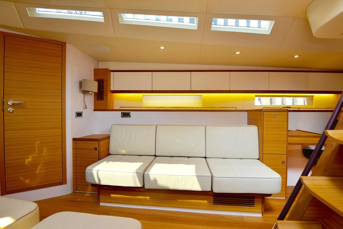 The salon features a comfortable seating area with ample natural light from overhead skylights. aboard MAZARIN 72 CRUISER RACER Yacht for Sale