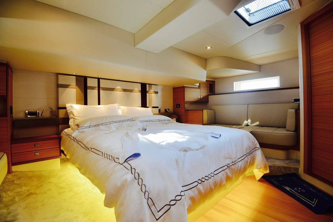 The master stateroom features a luxurious bed with elegant bedding and ample natural light. aboard MAZARIN 72 CRUISER RACER Yacht for Sale