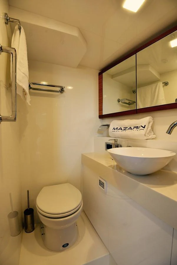 The yacht's bathroom features a modern design with a sleek sink and a compact toilet. aboard MAZARIN 72 CRUISER RACER Yacht for Sale