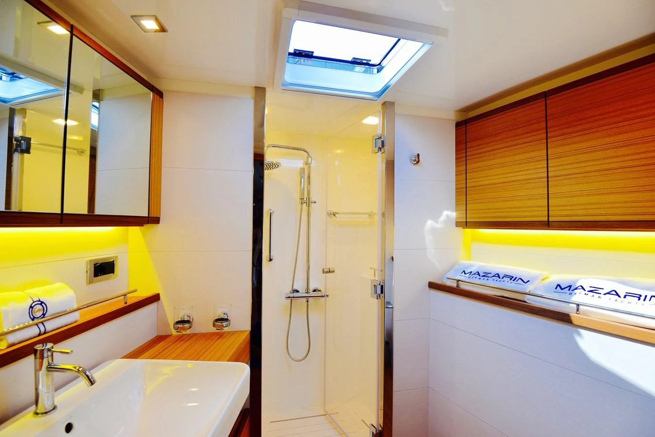 The yacht's bathroom features modern fixtures, a spacious shower, and ample natural light. aboard MAZARIN 72 CRUISER RACER Yacht for Sale