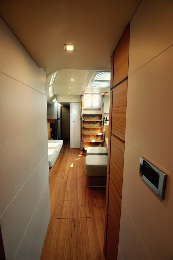 The yacht's interior features a modern hallway with wooden flooring and sleek design elements. aboard MAZARIN 72 CRUISER RACER Yacht for Sale