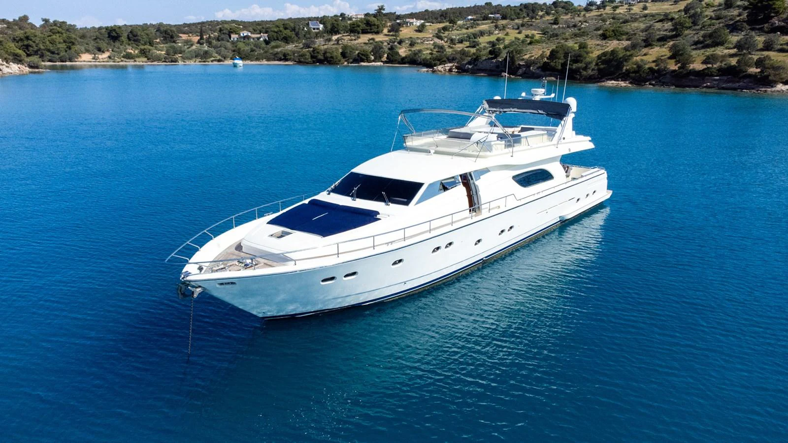A sleek white yacht cruises through tranquil blue waters, showcasing its elegant design and spacious decks. aboard PUMABAY Yacht for Sale