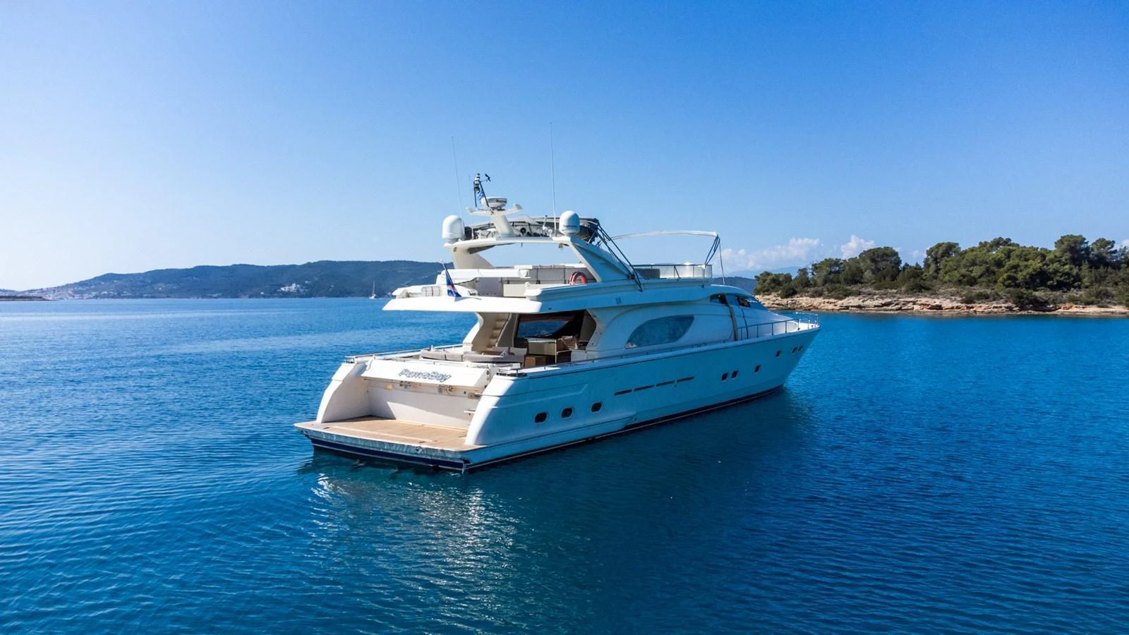 A sleek yacht cruises gracefully on calm blue waters, showcasing its elegant design. aboard PUMABAY Yacht for Sale