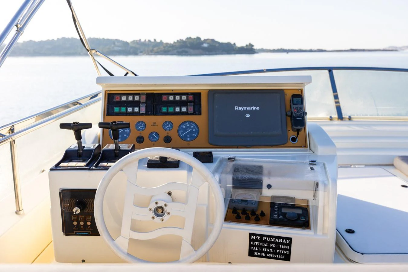 The helm station features advanced navigation equipment and a sleek steering wheel, offering a commanding view for the captain. aboard PUMABAY Yacht for Sale