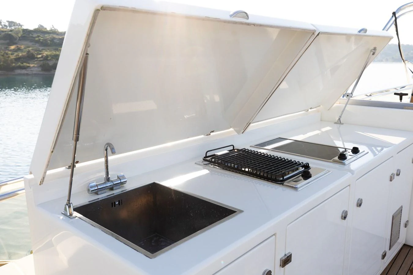 The yacht features a sleek outdoor galley with a sink, grill, and stove, perfect for alfresco dining. aboard PUMABAY Yacht for Sale