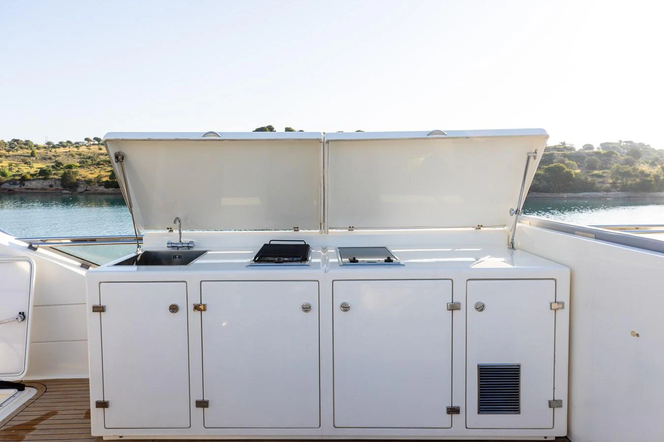 The yacht features a sleek outdoor galley with a sink and grill, perfect for alfresco dining. aboard PUMABAY Yacht for Sale