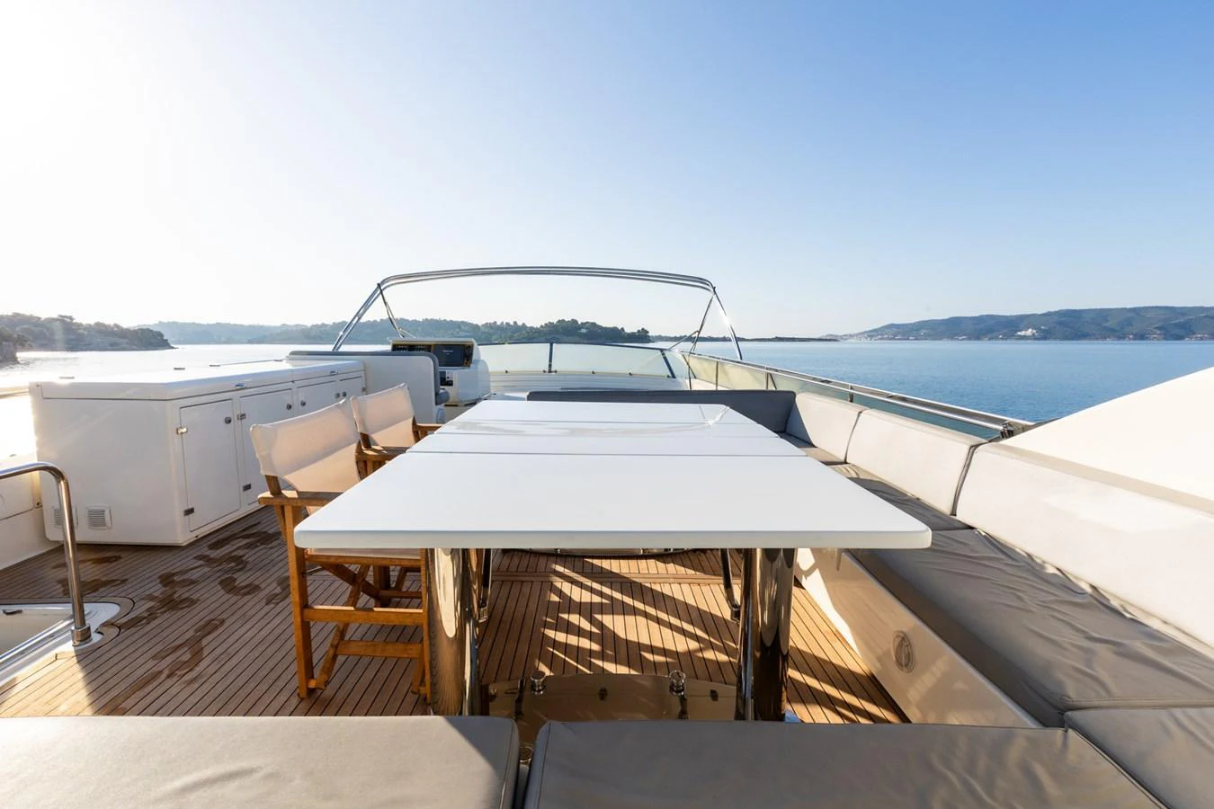 The sundeck offers a spacious and inviting area with ample seating and a large table for outdoor dining. aboard PUMABAY Yacht for Sale