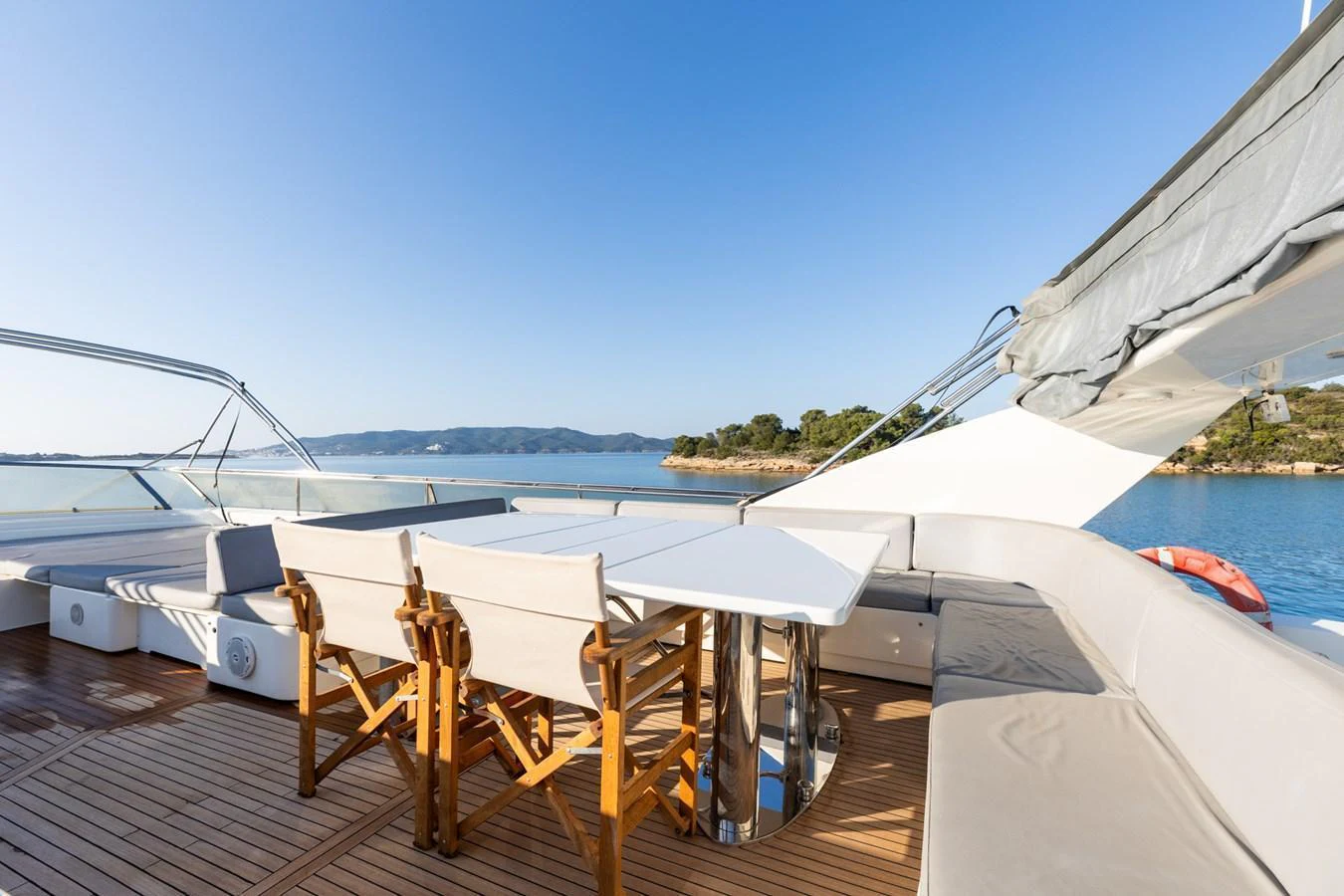 The aft deck features a stylish dining area with a stunning view of the surrounding waters. aboard PUMABAY Yacht for Sale
