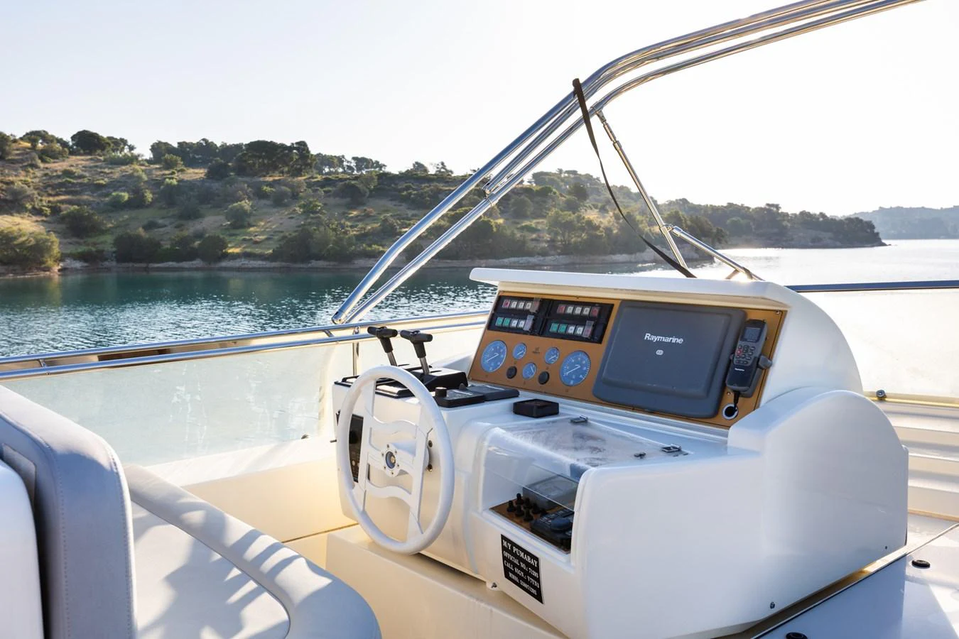 The helm station offers a commanding view with modern navigation equipment and comfortable seating. aboard PUMABAY Yacht for Sale