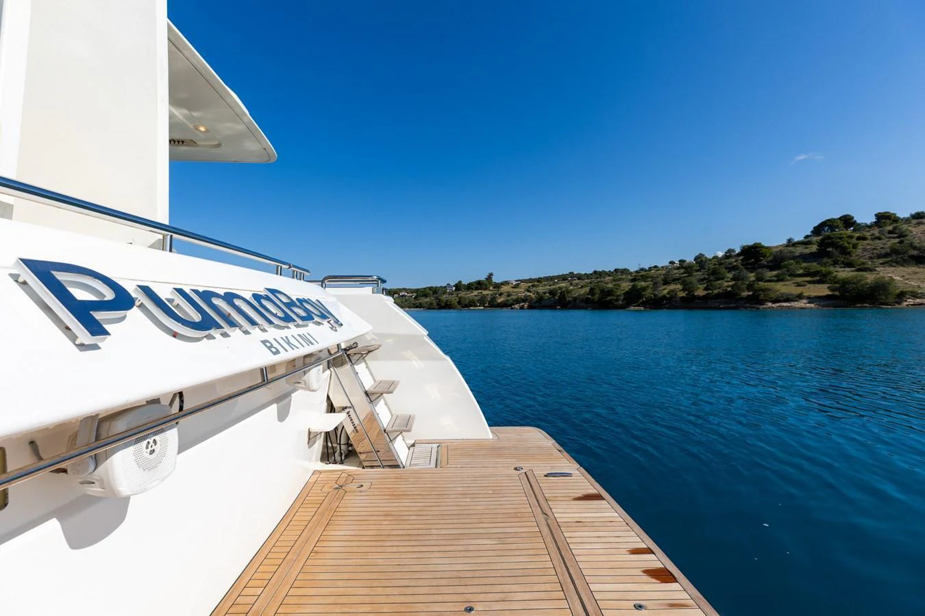 The aft deck of the yacht offers a serene view of the water and surrounding landscape. aboard PUMABAY Yacht for Sale