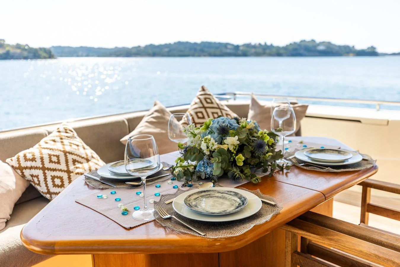 An elegant dining setup on the aft deck offers a picturesque view of the water. aboard PUMABAY Yacht for Sale