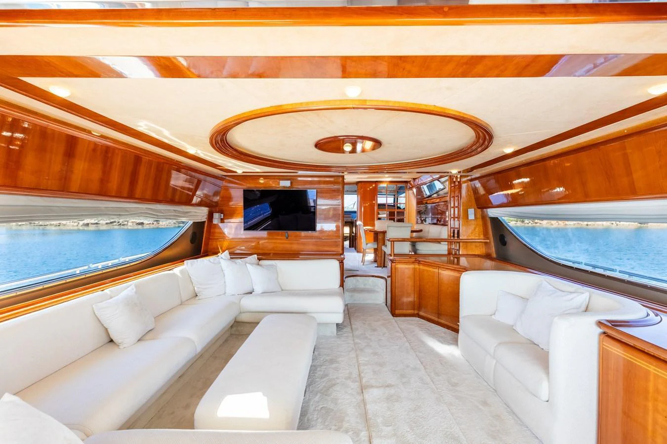 The yacht's salon features luxurious seating with elegant wood finishes and large windows offering stunning views. aboard PUMABAY Yacht for Sale