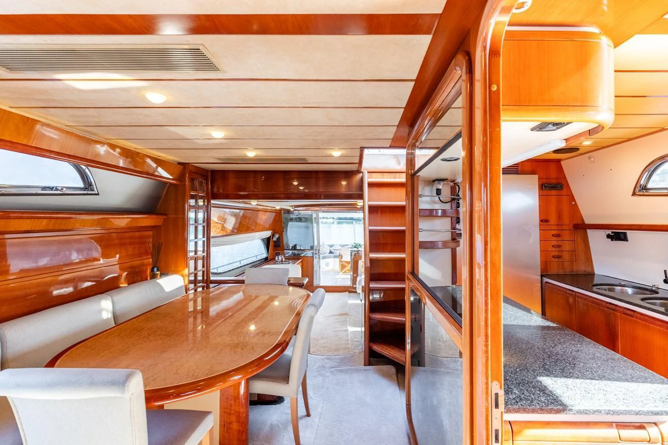 The yacht's saloon features a spacious dining area with elegant wood finishes and ample natural light. aboard PUMABAY Yacht for Sale