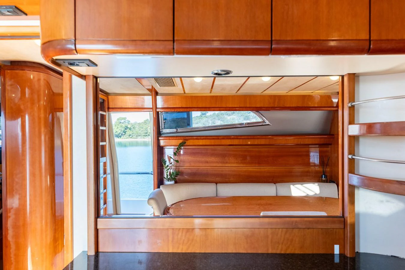 The yacht's salon features elegant wood paneling and a comfortable seating area with a view of the water. aboard PUMABAY Yacht for Sale