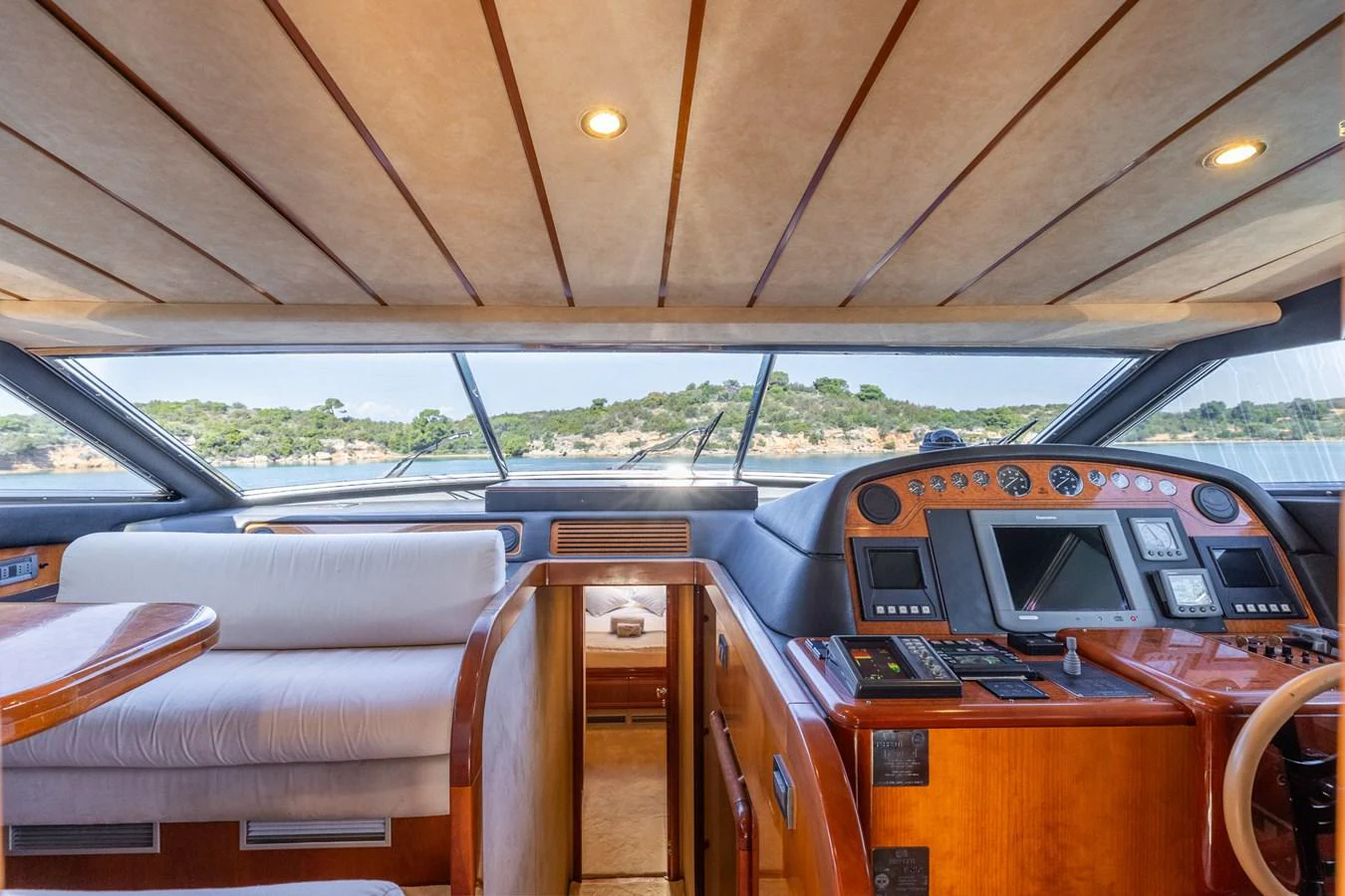 The helm area offers a commanding view with luxurious wood finishes and state-of-the-art navigation equipment. aboard PUMABAY Yacht for Sale