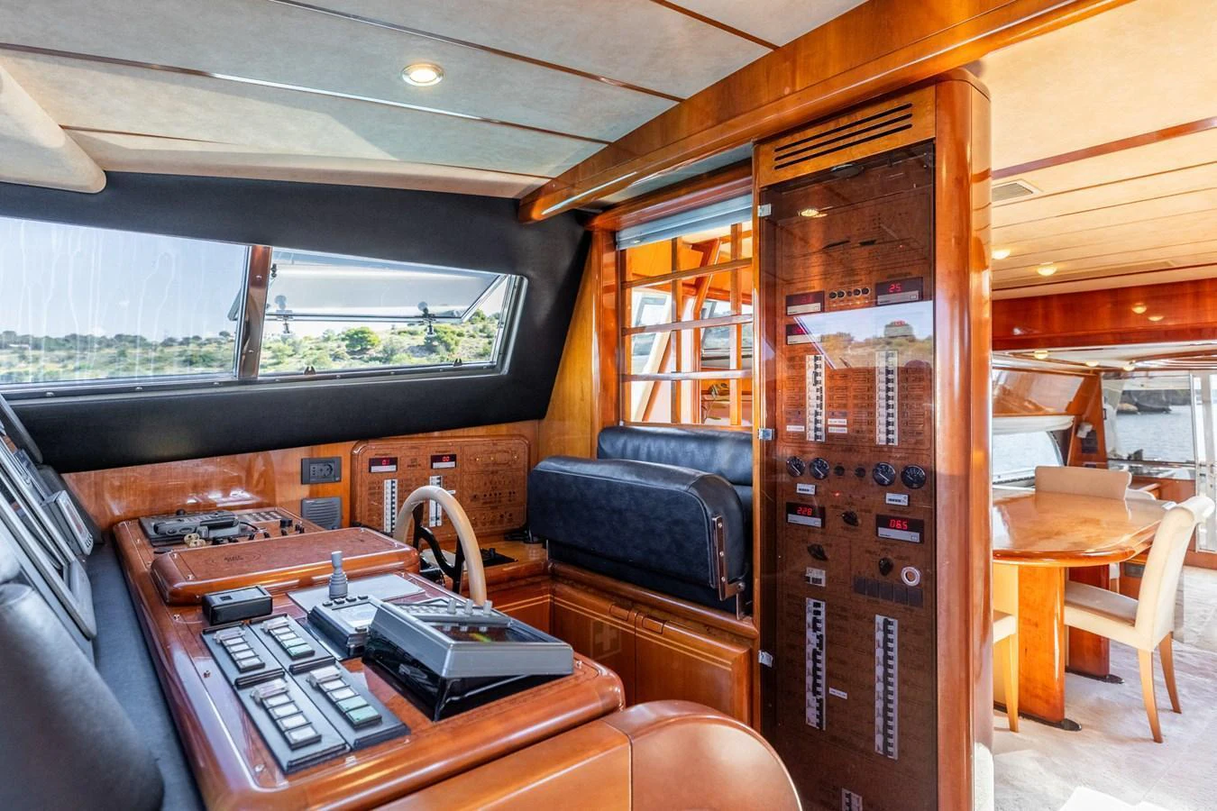 The helm station features sophisticated navigation equipment and luxurious wood finishes. aboard PUMABAY Yacht for Sale