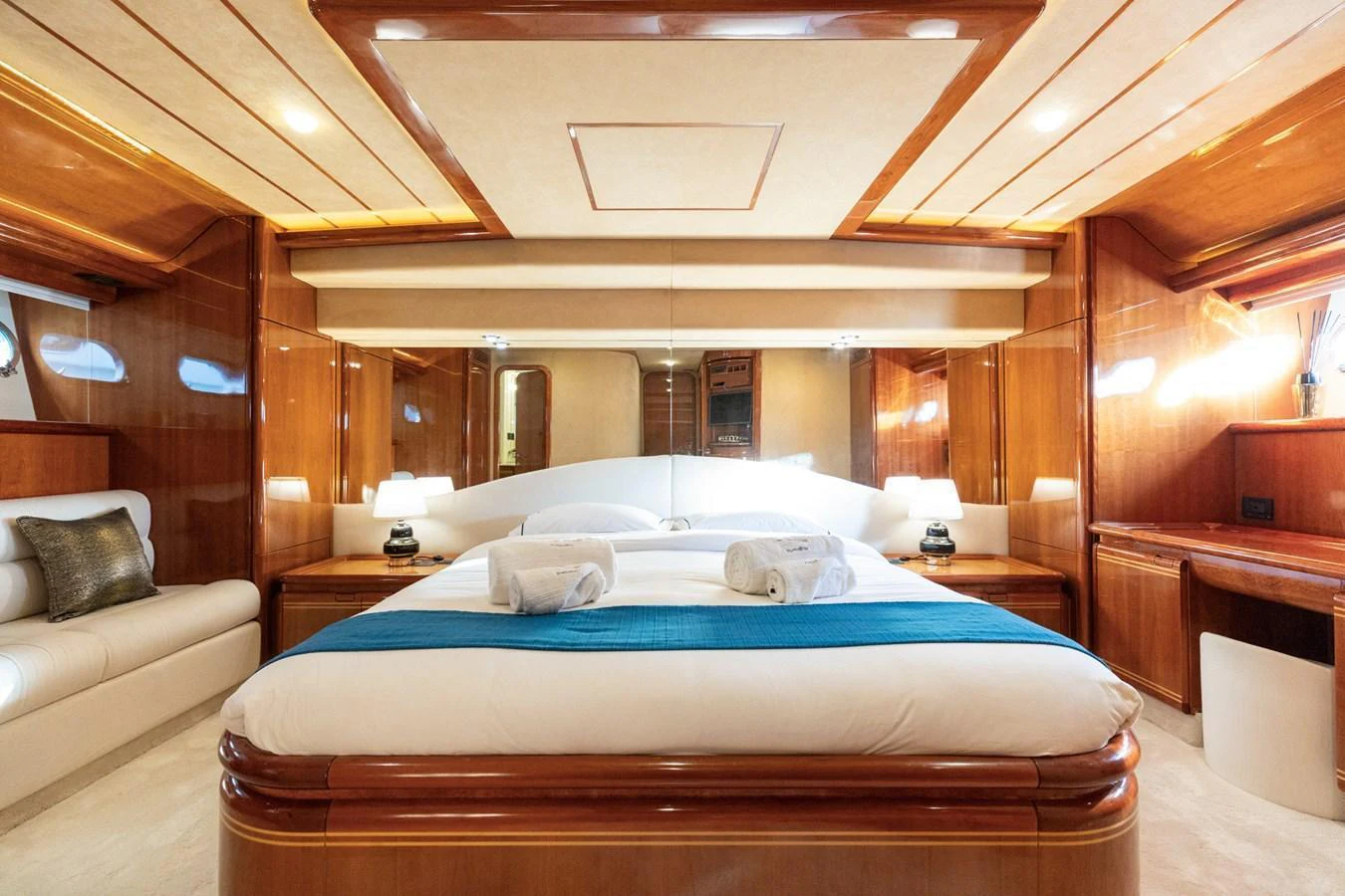 The master stateroom features a luxurious bed with elegant wood paneling and ample natural light. aboard PUMABAY Yacht for Sale