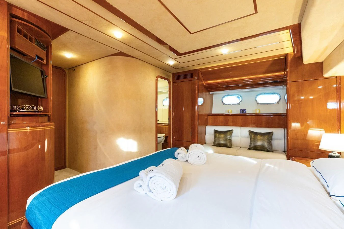 The master stateroom features luxurious bedding and elegant wood finishes, creating a serene and comfortable retreat. aboard PUMABAY Yacht for Sale