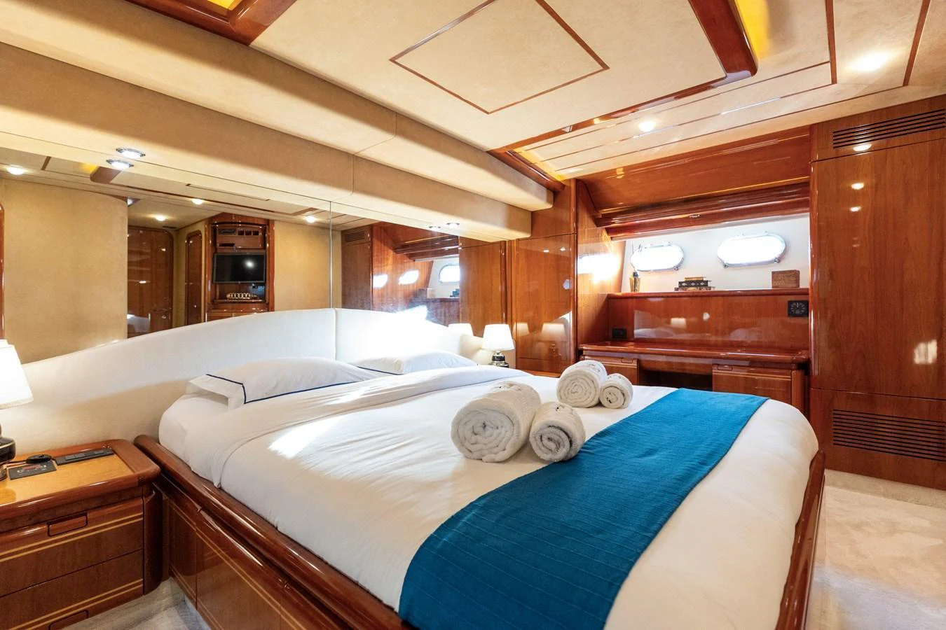 The master stateroom features a luxurious bed with plush linens and elegant wood finishes. aboard PUMABAY Yacht for Sale