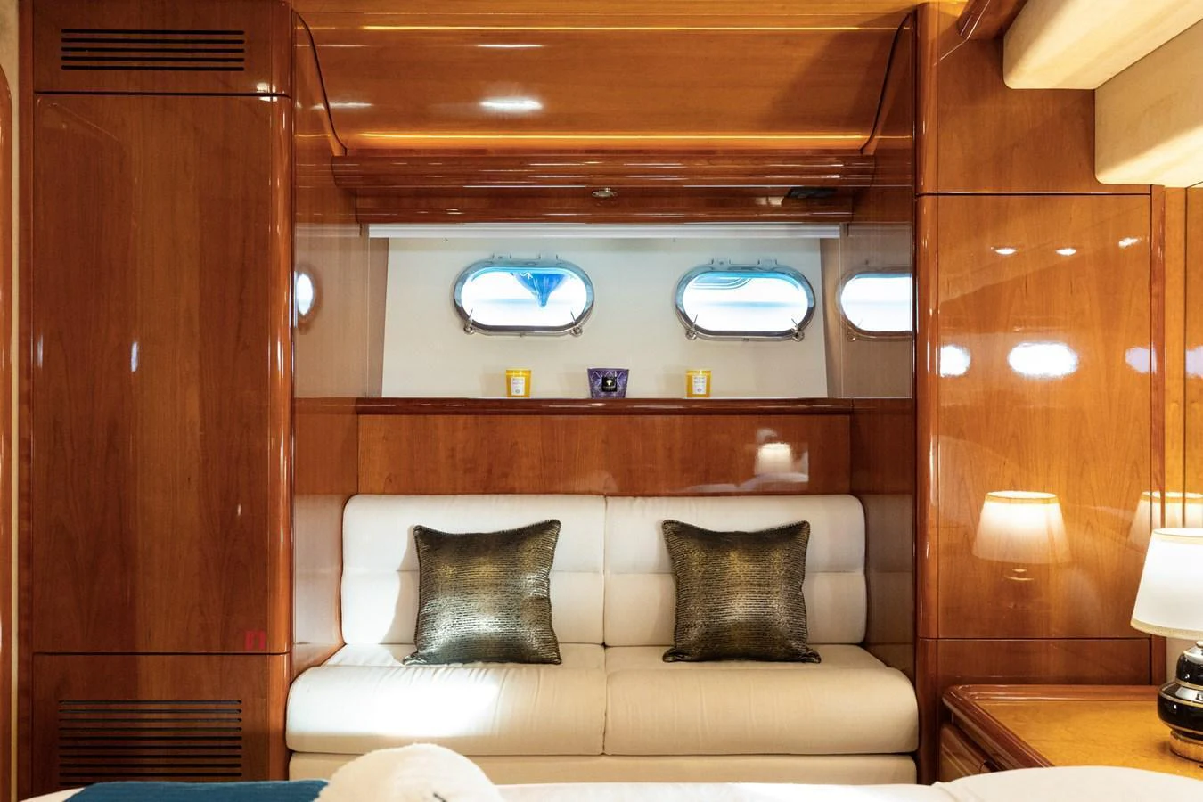 The stateroom features a cozy seating area with elegant wood paneling and soft lighting. aboard PUMABAY Yacht for Sale