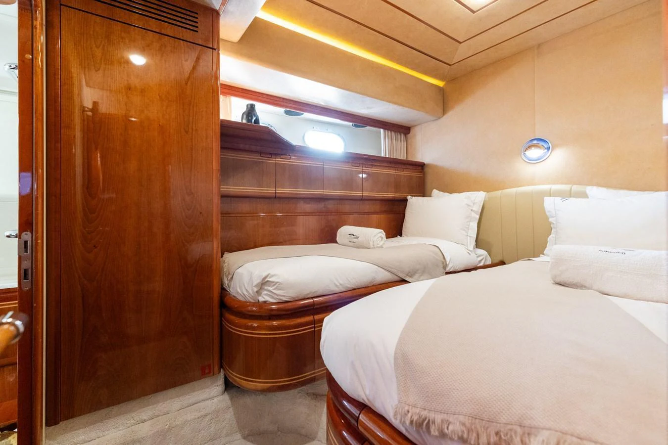 The guest stateroom features twin beds with luxurious bedding and warm wood finishes. aboard PUMABAY Yacht for Sale