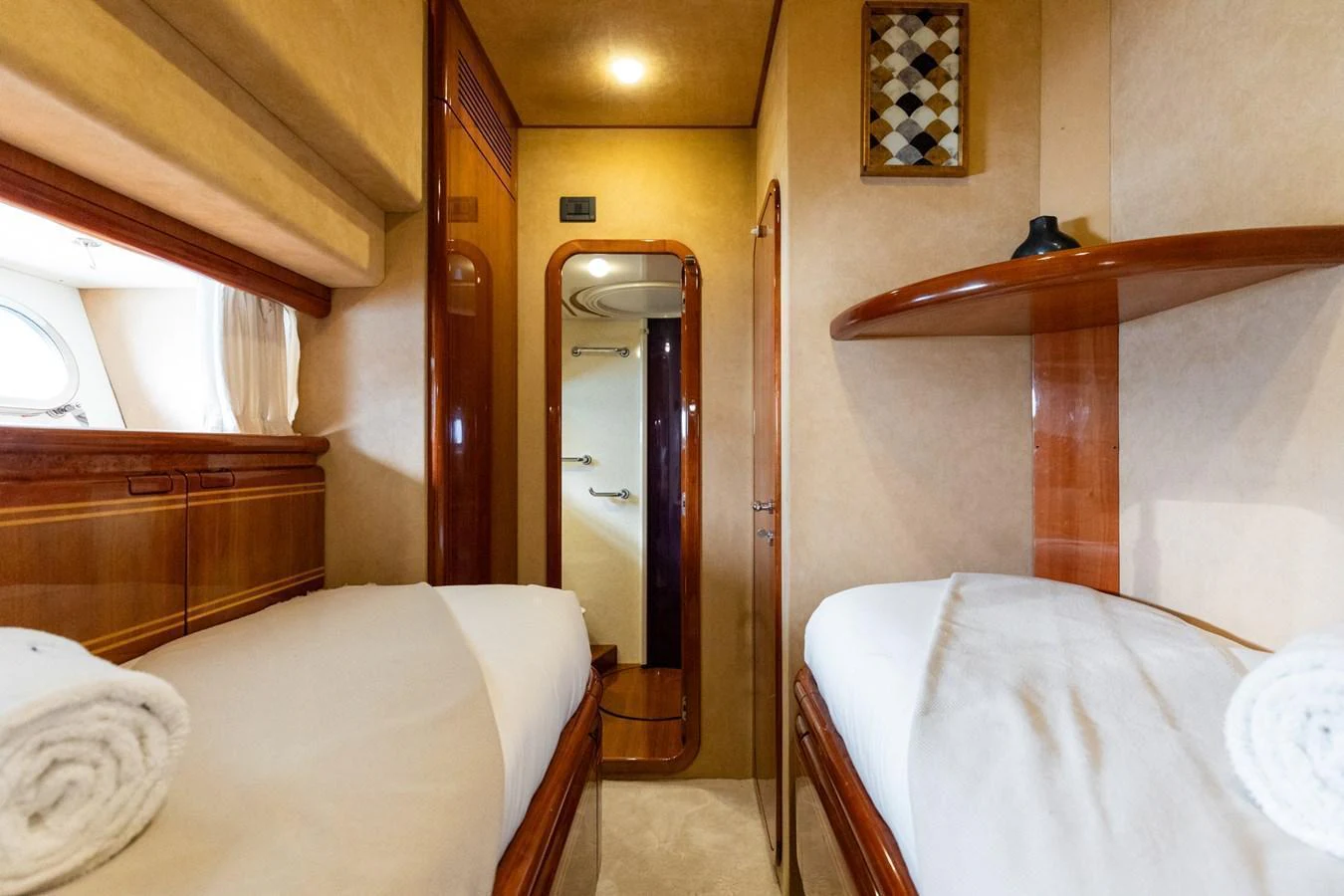 The guest cabin features twin beds with warm wood finishes and soft lighting. aboard PUMABAY Yacht for Sale