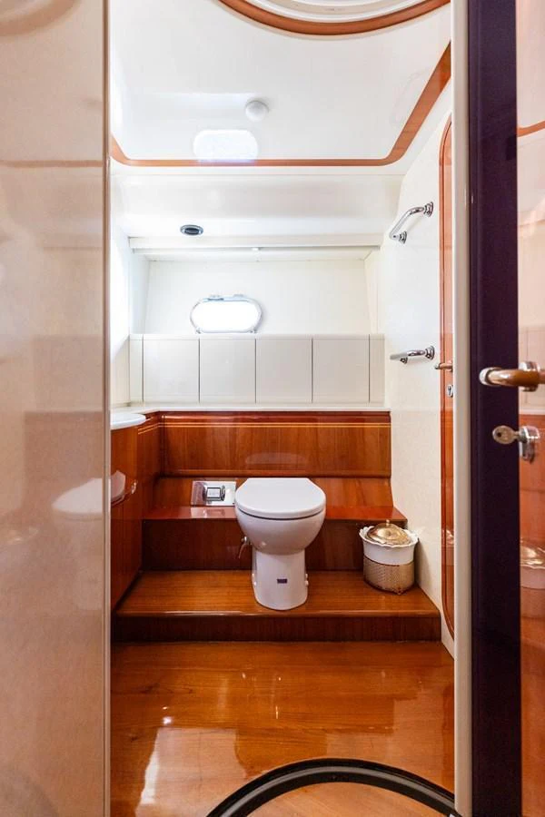 The yacht's head features a sleek, modern design with polished wood finishes and ample lighting. aboard PUMABAY Yacht for Sale