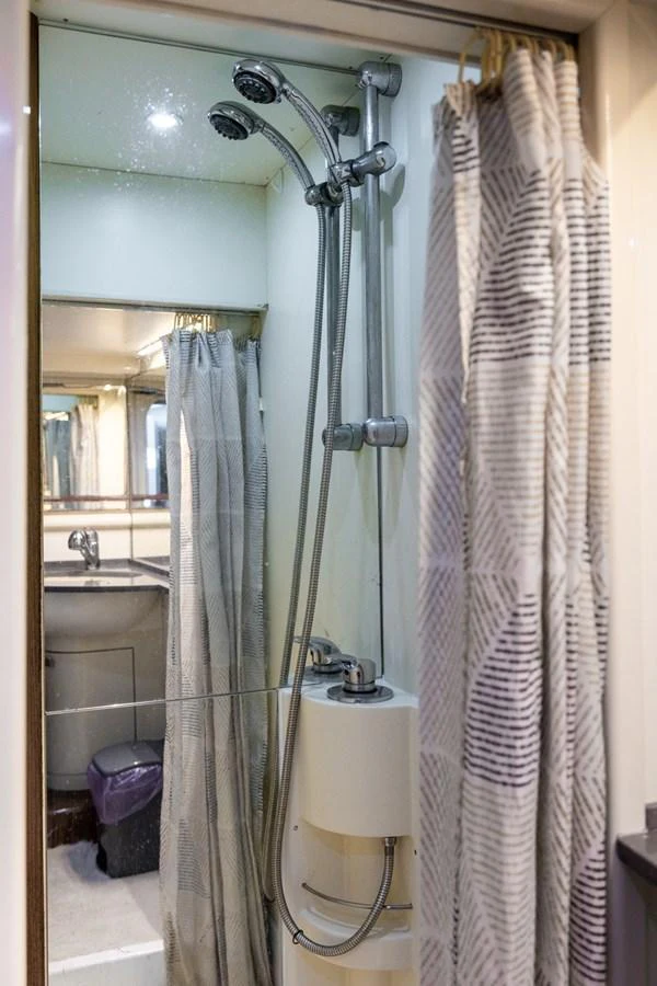 The yacht's bathroom features a modern shower with dual showerheads and a stylish curtain. aboard PUMABAY Yacht for Sale
