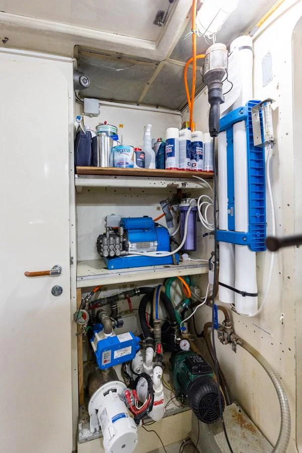 The image showcases the well-organized engine room with various equipment and maintenance supplies. aboard PUMABAY Yacht for Sale