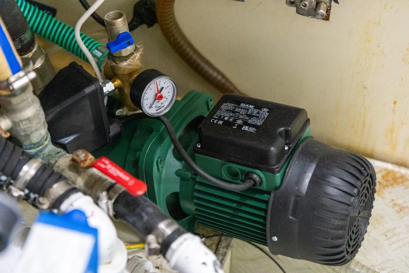 A close-up view of the yacht's mechanical equipment, showcasing a green motor and various pipes and gauges. aboard PUMABAY Yacht for Sale