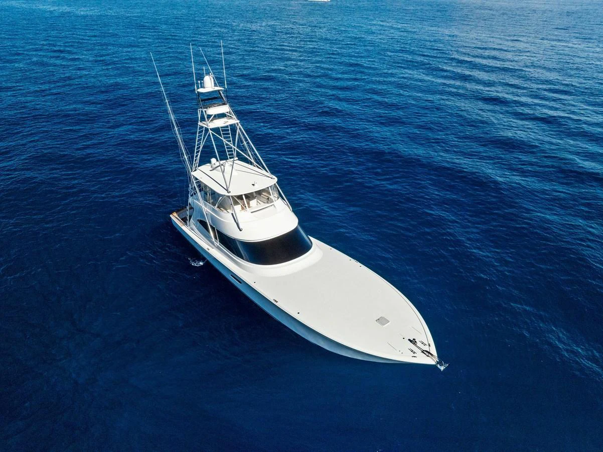 A sleek yacht glides gracefully over the deep blue ocean waters. aboard CATCH 23 Yacht for Sale