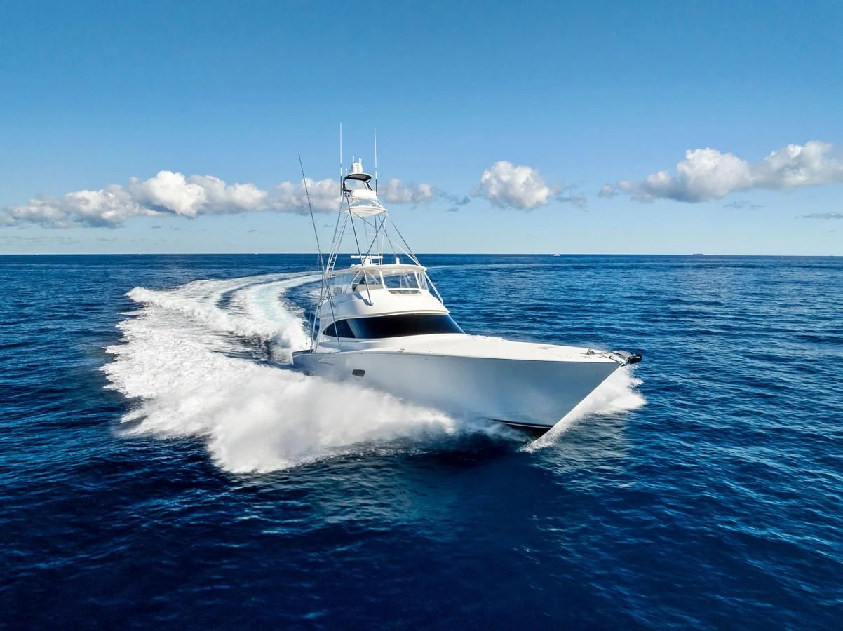A sleek yacht cuts through the open ocean, showcasing its powerful performance and elegant design. aboard CATCH 23 Yacht for Sale