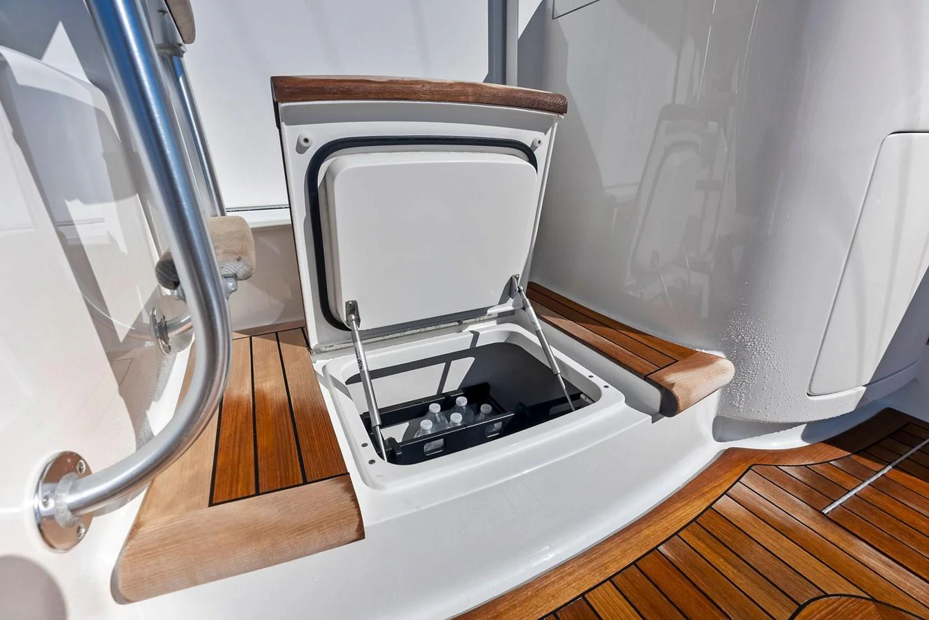 A sleek storage compartment with a wooden finish, perfect for keeping essentials secure and accessible. aboard CATCH 23 Yacht for Sale