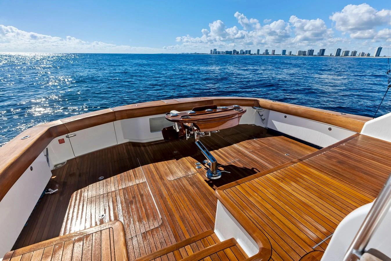 The aft deck offers a spacious and inviting area with beautiful wooden flooring, perfect for enjoying the open sea. aboard CATCH 23 Yacht for Sale