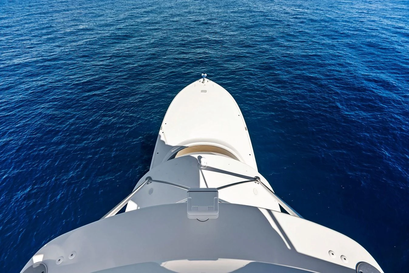 The yacht's bow cuts through the deep blue waters, showcasing its sleek design. aboard CATCH 23 Yacht for Sale