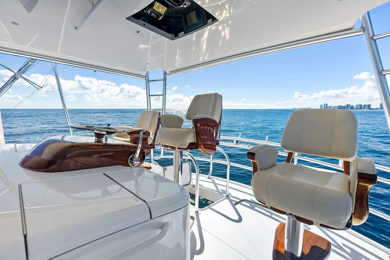 The yacht's helm offers a luxurious and comfortable space with plush seating and panoramic ocean views. aboard CATCH 23 Yacht for Sale