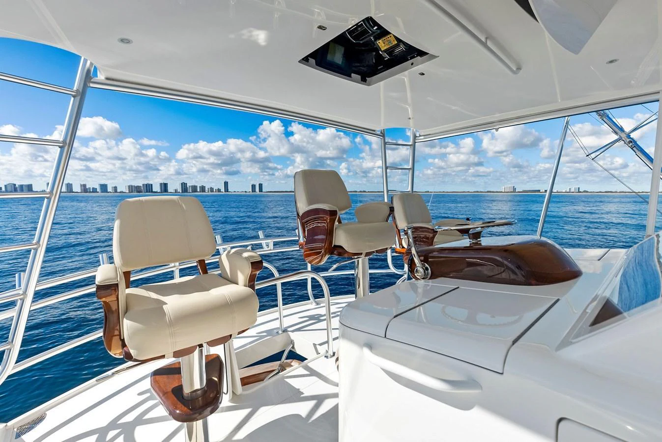 The flybridge offers a panoramic view with comfortable seating and a sleek helm station. aboard CATCH 23 Yacht for Sale