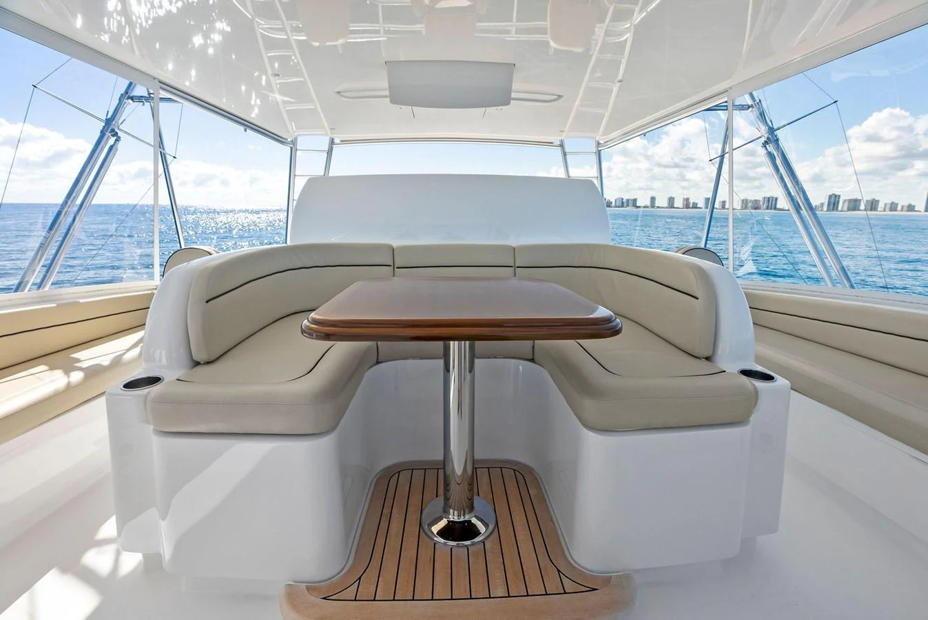 The flybridge offers a spacious seating area with a central table, perfect for enjoying the view. aboard CATCH 23 Yacht for Sale
