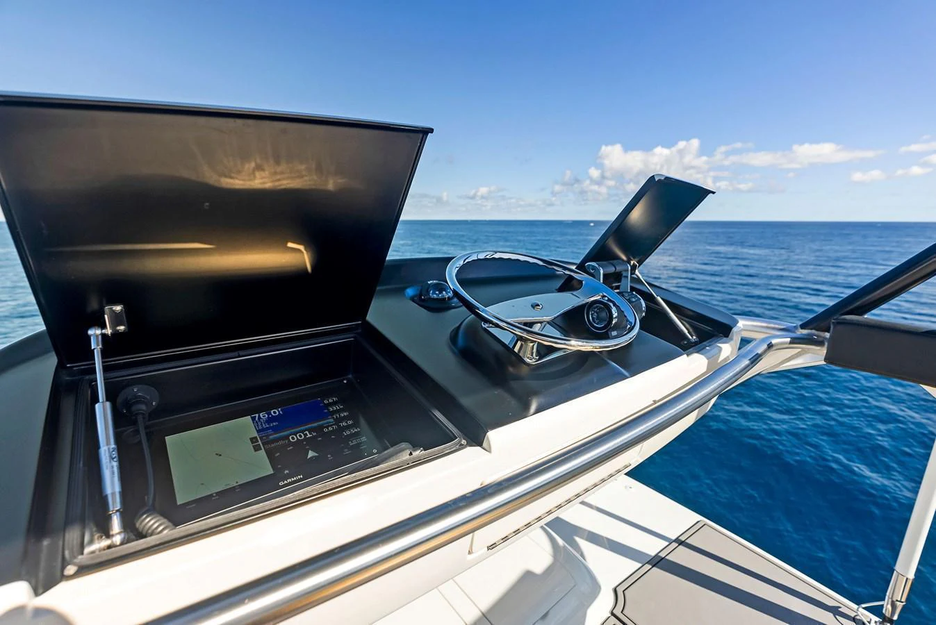 The helm station offers a sleek, modern design with advanced navigation equipment and a stunning ocean view. aboard CATCH 23 Yacht for Sale