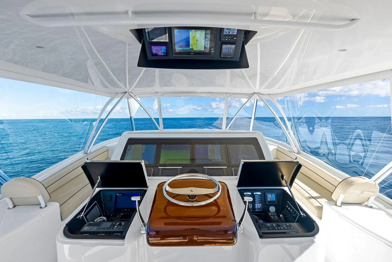 The helm station offers a commanding view with state-of-the-art navigation equipment and luxurious finishes. aboard CATCH 23 Yacht for Sale