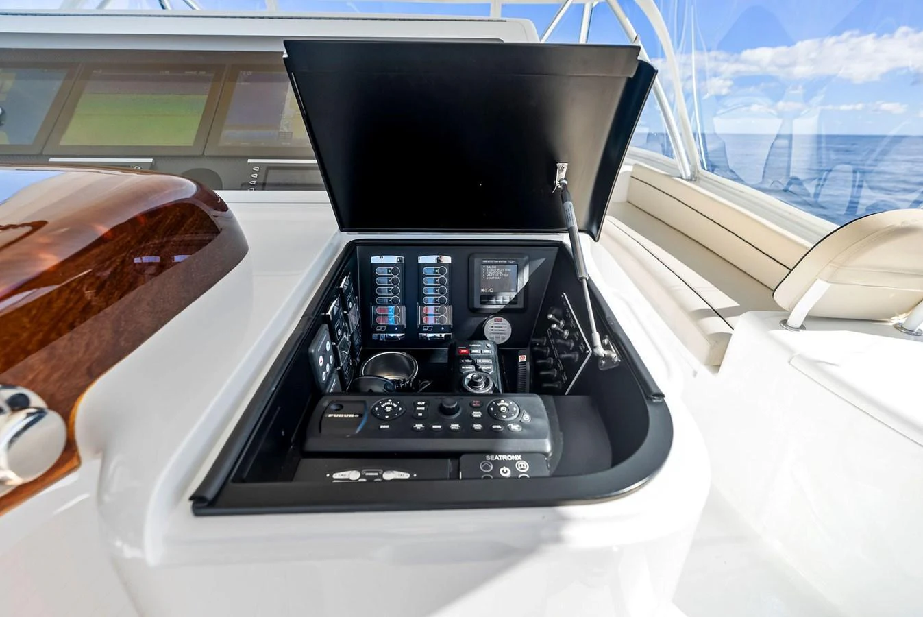A close-up view of the yacht's helm control panel with advanced navigation and control systems. aboard CATCH 23 Yacht for Sale