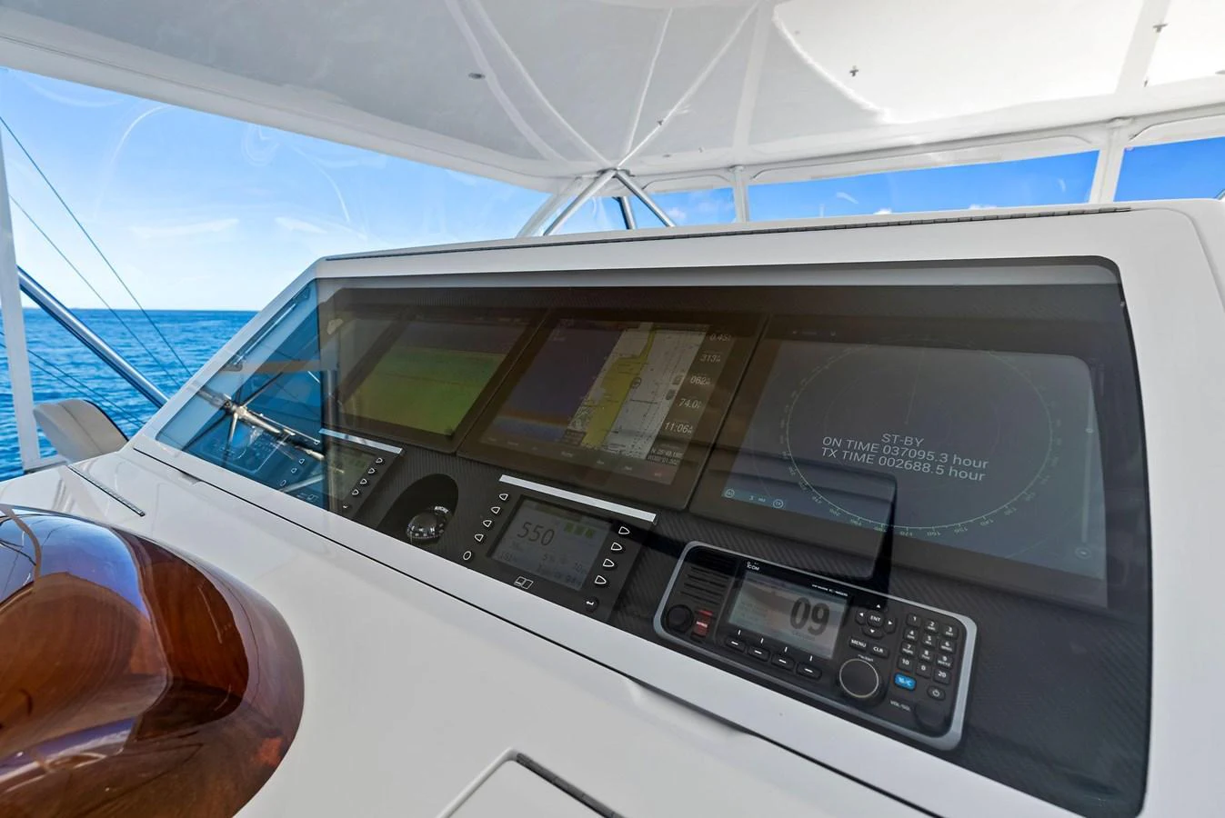 The helm station features advanced navigation and control systems with a clear view of the ocean. aboard CATCH 23 Yacht for Sale