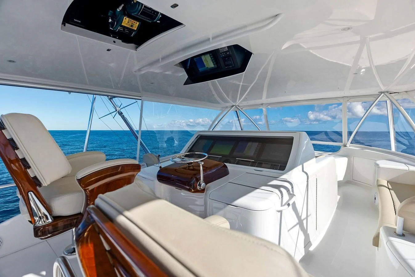 The helm station offers a commanding view with luxurious seating and state-of-the-art navigation equipment. aboard CATCH 23 Yacht for Sale