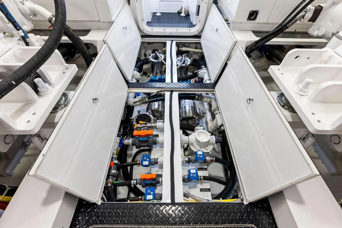 The image showcases the meticulously organized engine room with open hatches revealing the machinery and systems. aboard CATCH 23 Yacht for Sale