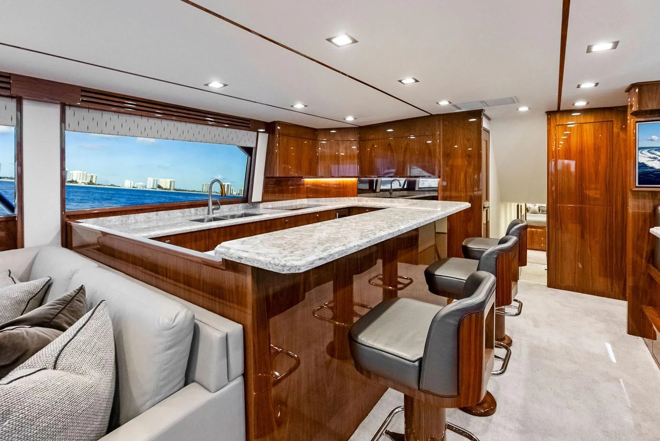 The galley features a sleek design with a marble countertop and comfortable bar seating. aboard CATCH 23 Yacht for Sale