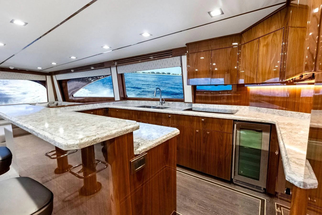 The yacht's galley features luxurious wood cabinetry and a spacious marble countertop. aboard CATCH 23 Yacht for Sale