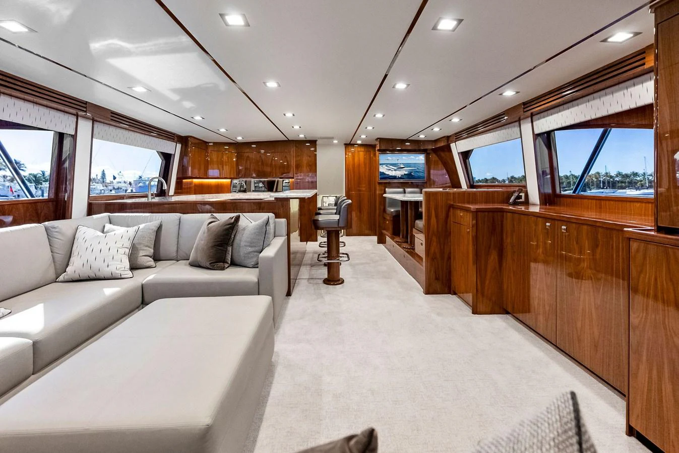 The yacht's salon features luxurious seating and elegant wooden cabinetry, creating a warm and inviting atmosphere. aboard CATCH 23 Yacht for Sale