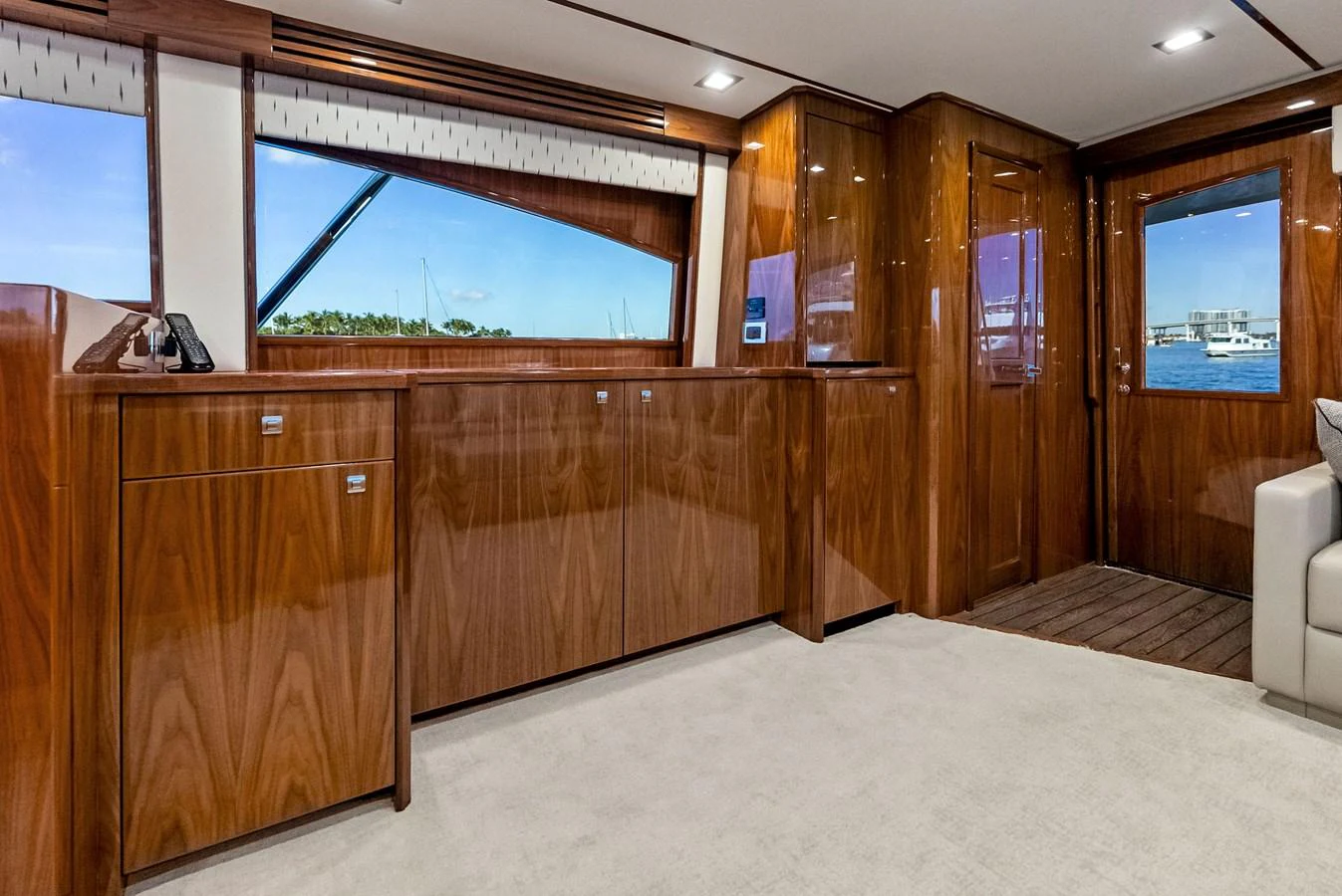 The yacht's interior features polished wood cabinetry and large windows offering scenic views. aboard CATCH 23 Yacht for Sale
